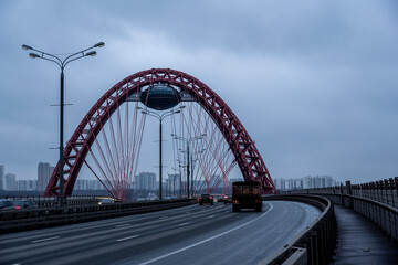 Fototapeta na wymiar red cable-stayed bridge and freeway at sunrise on winter morning