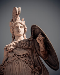Athena, the ancient Greek goddess of knowledge and wisdom under dark cloudy sky, Athens, Greece.