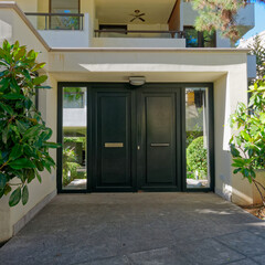 contemporary residential apartment building  front entrance metal and glass door