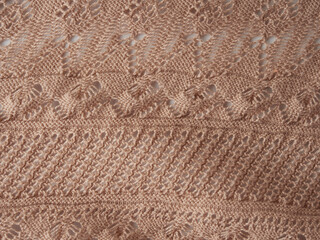 Knitted background. Knitted texture. A sample of knitting from wool. Knitting Pattern.