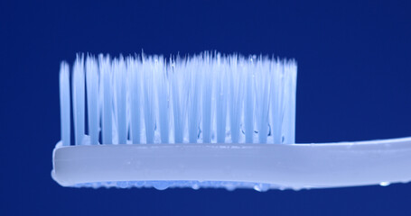 White toothbrush on blue background.