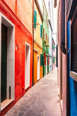Fototapeta na wymiar Narrow street with colorful houses on Burano island, Venice, Italy