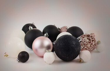 Christmas balls to decorate a Christmas tree on a white background. Black, white and pink colors.   New Year.Christmas. Soft focus.