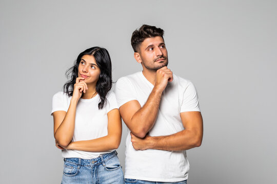 Young Couple Thinking Over Isolated White Background