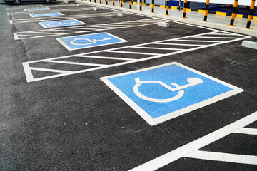 Multiple parking spaces reserved for disabled shoppers in retail parking lots.
