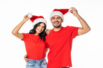 Young happy couple in Christmas hats isolated over white background
