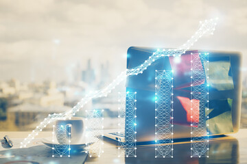 Financial graph colorful drawing and table with computer on background. Double exposure. Concept of...
