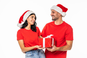Happy couple with christmas present over white background.