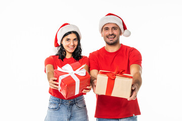 Young couple with Christmas gifts on white background