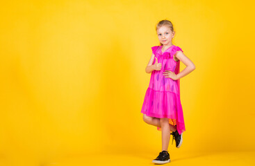 just having fun. trendy fashionable look. copy space. beautiful teen girl with thumb up gesture. kid fashion style. female natural beauty. happy childhood. cute child on yellow background