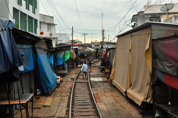 Fototapeta na wymiar Landscape view of Rom Hoop Market (The folding umbrella market ) at Samut Sakhon city, Thailand 