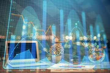 Double exposure of chart and financial info and work space with computer background. Concept of international online trading.