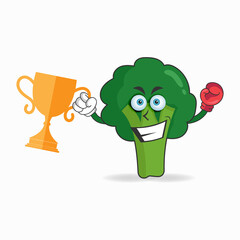 The Broccoli mascot character wins a boxing trophy. vector illustration