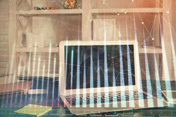 Financial graph colorful drawing and table with computer on background. Double exposure. Concept of...