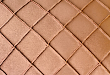 Textured textile, beige material with rhombus, ornament fabric background