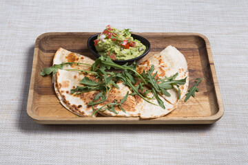 Quesadilla with guacamole sauce. Fresh, spicy.