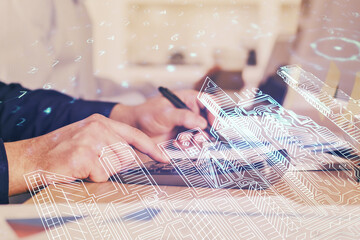 Abstract holographic city on man's hand writing notes background. Double exposure.