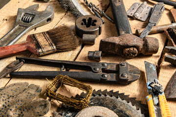 Old vintage household hand tools still life on a wooden background in a DIY and repair concept