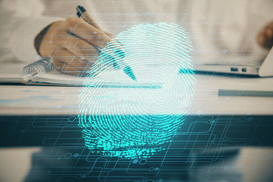 Blue fingerprint hologram over woman's hands taking notes background. Concept of protection. Double exposure