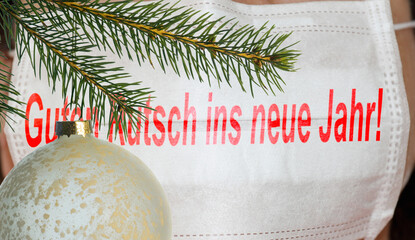 christmas decorations and New Year's wish on a surgical mask in German