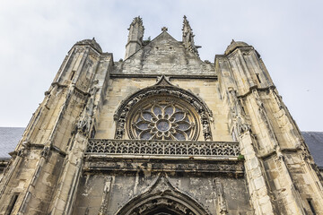 Fototapeta premium Built in heart of Fecamp XVI century Saint-Etienne church dominates now wearing Norman city: Renaissance portal, flamboyant Gothic steeple. Fecamp, Seine-Maritime department, Haute-Normandie, France.