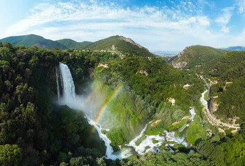 Aerial view. Water discharge, strong, maximum flow. Rainbow. The Cascata delle Marmore is a the largest man-made waterfall. Terni in Umbria Italy. Hydroelectric power plant - obrazy, fototapety, plakaty
