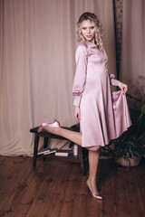 Woman in tender pink silk fashion dress 