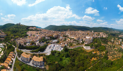 Fototapeta na wymiar Panoramic aerial view of Narni (Terni, Umbria, Italy), medieval city with a rich history. Houses made of stone on top of the mountain. Incredible views. Summer day. Europe travel and vacation concept