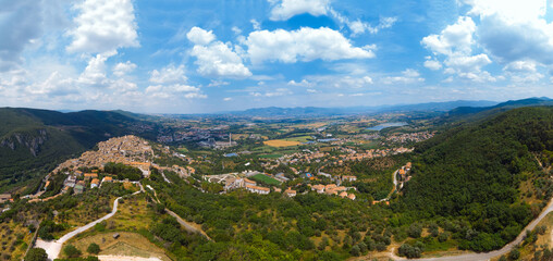 Fototapeta na wymiar Panoramic aerial view from top of mountain of Narni (Terni, Umbria, Italy), medieval city with a rich history. Houses made of stone. Incredible views. Summer day. Europe travel and vacation concept