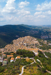 Fototapeta na wymiar Panoramic aerial view from top of mountain of Narni (Terni, Umbria, Italy), medieval city. Houses made of stone. Incredible views. Vertical photo. Europe travel and vacation concept