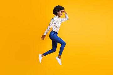 Fototapeta na wymiar Full size profile side photo of brunette trendy girl wear blue pants white shirt jump run look copyspace isolated on yellow color background
