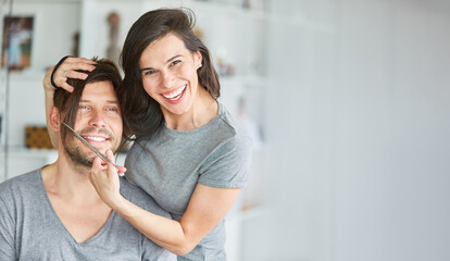 Young couple making mischief with woman's long hair