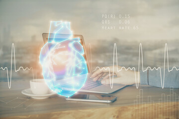 Heart drawing with man working on computer on background. Medical concept. Double exposure.