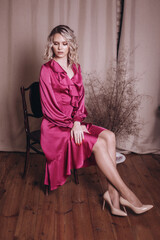 Obraz na płótnie Canvas Woman in tender pink silk fashion dress 