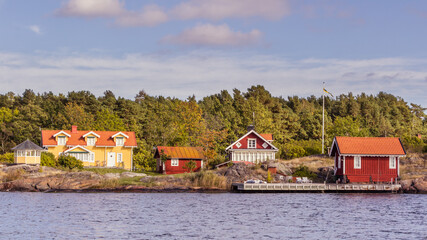 Red cottages on small island in in South Sweden