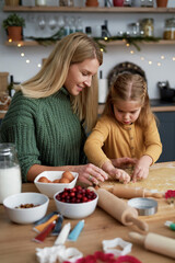 Mom and daughter making Christmas cookies together