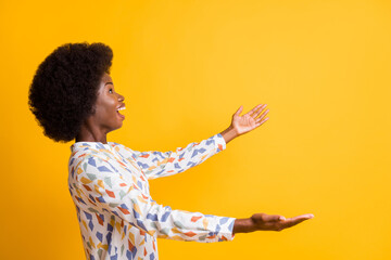 Profile photo of funny astonished person look empty space hands catch open mouth isolated on yellow color background