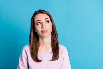 Fototapeta premium Closeup photo of wondered clever not sure lady look up empty space have many doubts about making important decision hesitation wear casual purple sweatshirt isolated blue color background