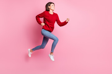 Fototapeta na wymiar Full length body size portrait of nice girl jumping high wearing casual outfit smiling running fast isolated on pink color background