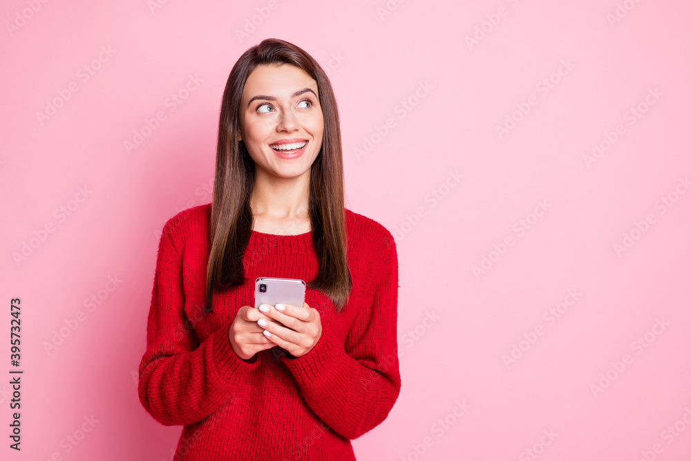 Sticker Photo of charming girl hold telephone look up empty space wear red sweater isolated pink color background