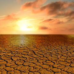 Apocalyptic Landschatf. Cracked earth and red sunset. Super realistic photo.