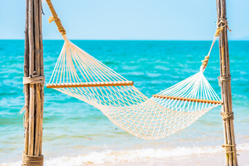 Empty white hammock around sea beach ocean