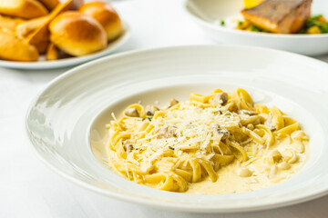 Yellow Spaghetti carbonara with white cream sauce in plate