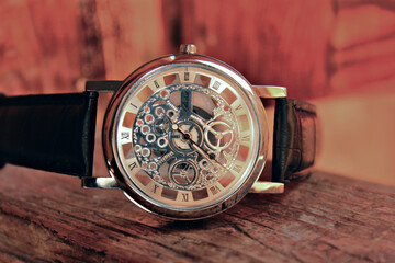Closeup of elegant men watch with a visible mechanism