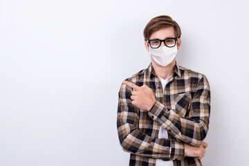 Portrait of nice healthy content guy in demonstrating copy empty space info wearing safety mask isolated on white light color background