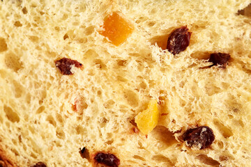 Detail of spongy pastry bread dough, Christmas panettone with candied fruit and raisins.