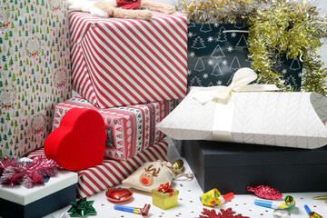 Various gift boxes on the table with Christmas ornaments. Winter's holiday celebration and gifting concept. 