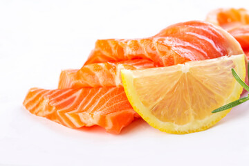 Fresh salmon sashimi slices and lemon