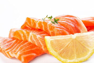 Fresh salmon sashimi slices and lemon