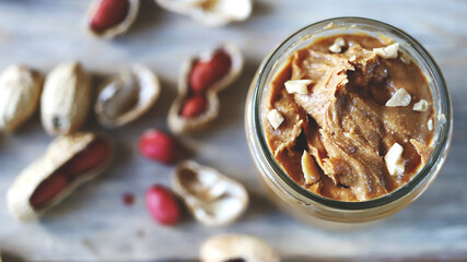 Peanut butter in a jar. Peanuts in shells.
